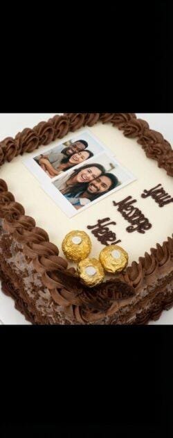 Round personalised photo celebration cake with smooth fresh cream icing, edible photo print, chocolate rosettes, Ferrero Rocher chocolates, chocolate curls and personalised message, handmade by Cake Palace UK.