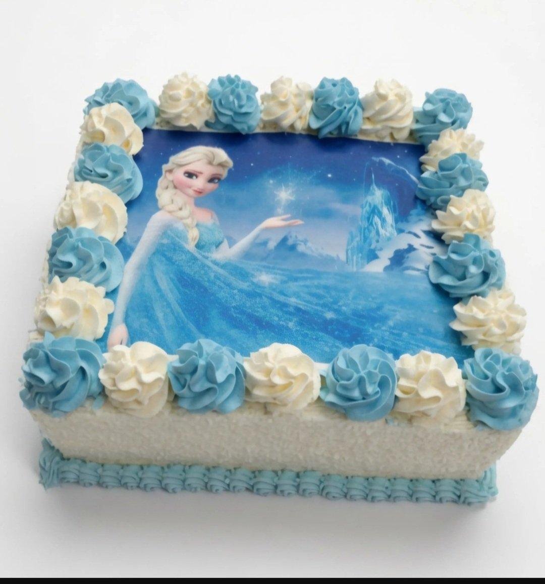 Egg-Free Frozen Princess Photo Birthday Cake | Personalised Cake Square egg-free Frozen Princess photo birthday cake featuring a premium edible Frozen Princess image, blue and white fresh dairy topping swirls, desiccated coconut-coated sides, blue piped border, and a personalised edible message for children's birthday celebrations.
