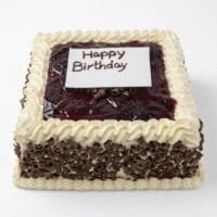 Egg-free Black Forest birthday cake with soft chocolate sponge, fresh dairy topping, chocolate curls around the sides, rich cherry glaze topping, personalised edible message plaque, and elegant piped border. Ideal for birthdays, anniversaries, and special occasions.