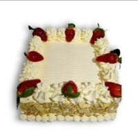 Egg-free strawberry celebration cake decorated with fresh strawberries, smooth vanilla cream, almond flake sides and space for a personalised message.