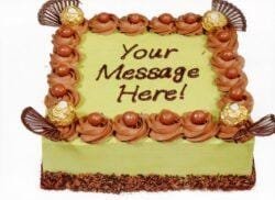 Egg-free pistachio fresh cream cake decorated with Ferrero Rocher chocolates, chocolate curls, chocolate pearls, and personalised message