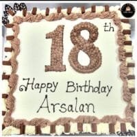 18th birthday egg-free fresh cream cake with chocolate piping, chocolate finger bars, decorative chocolate leaves, and personalised message
