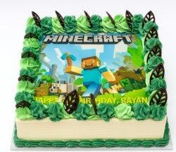 Minecraft photo birthday cake with edible image, green fresh cream rosettes and chocolate leaf decorations