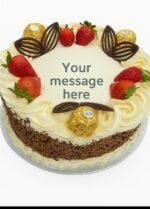 Signature Ferrero Strawberry Delight egg free fresh cream decorated with mix sprinkles on side, ferrero ,strawberry and chocolate fans on top birthday cake