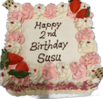 Egg Free square celebration cake decorated with pink and white cream swirls, fresh strawberries and a personalised birthday message