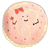 Round pink tooth-themed birthday cake with adorable tooth character and personalized message