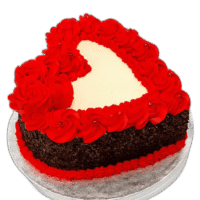 Egg Free red heart-shaped celebration cake with red rose decorations and chocolate flakes around the sides
