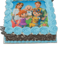 Egg Free Family Cartoon Photo Cake with an edible character image, blue cream swirls, chocolate curl sides and decorative chocolate leaves.