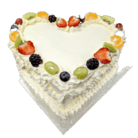 Egg Free heart shaped fresh fruit celebration cake decorated with strawberries, kiwi, grapes, blueberries, blackberries and mandarin segments.