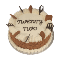 Egg Free Biscoff Celebration Cake decorated with Lotus Biscoff biscuits, Biscoff crumb coating, decorative chocolate pieces and a personalised message.