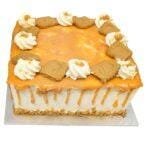 Top view of a square caramel fresh cream cake decorated with caramel glaze, fresh cream swirls, and crunchy biscuit pieces.