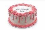Round white fresh cream birthday cake with pink drip decoration, pink piped borders, textured sides, and a personalised message.