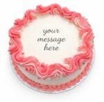 Top view of a white fresh cream cake featuring a pink drip border and space for a personalised birthday message.