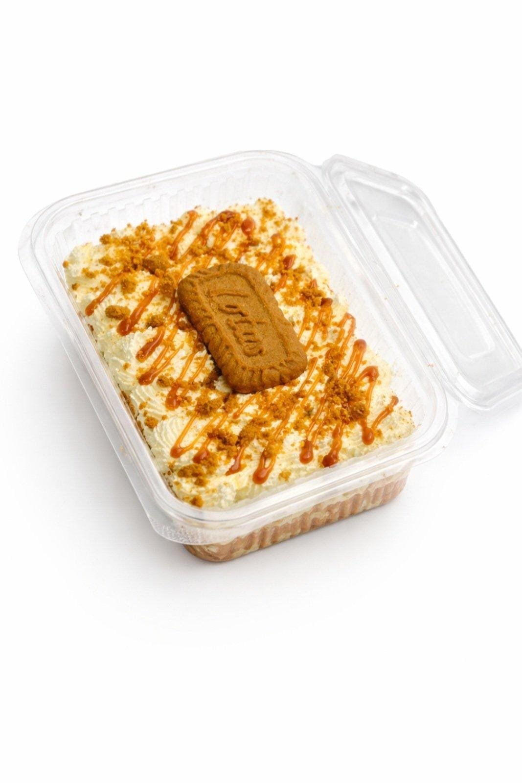 Lotus Milk Cake Lotus rosettes with biscuit halves. Cookie crumble border. Double Lotus sauce. Premium gold pearl finish.