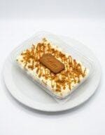 Lotus spread drizzle. Lotus biscuit crumbs. Whole Lotus biscuit in the centre. Caramel drizzle.