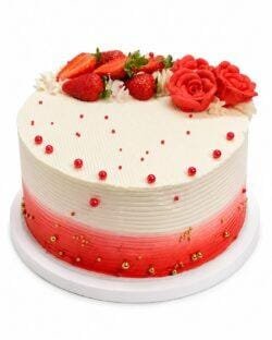 Top view of Tall Strawberry & Rose Celebration Cake with fresh strawberries, handcrafted red cream roses, elegant red and gold sugar pearls, and smooth fresh cream finish.