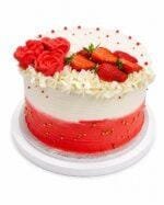 Luxury Tall Strawberry & Rose Fresh Cream Cake decorated with smooth white and red ombre fresh cream, handcrafted fresh cream roses, fresh strawberries, delicate white flowers, and gold sugar pearls. Freshly made in Sheffield.