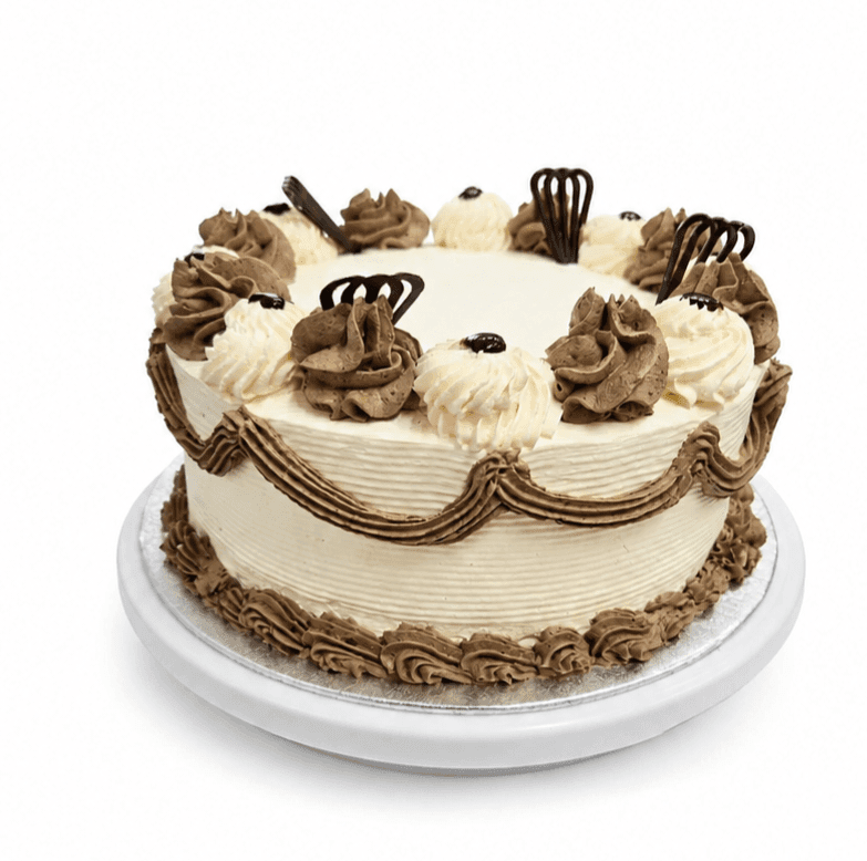 Classic Chocolate & Vanilla Celebration Cake Classic Chocolate & Vanilla Celebration Cake decorated with smooth vanilla buttercream, chocolate buttercream swirls, elegant chocolate piping, chocolate decorations, and a plain centre for a personalised message. Freshly made in Sheffield.