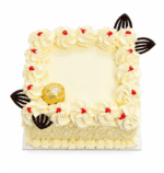 Top view of a square white chocolate celebration cake featuring vanilla buttercream swirls with red jam dots, decorative chocolate accents, a Ferrero Rocher chocolate, and a smooth blank centre designed for a personalised edible photo or celebration message.