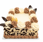 Ferrero Rocher & Chocolate Flake Celebration Cake with vanilla and chocolate buttercream swirls, white and dark chocolate flakes around the sides, Ferrero Rocher chocolates, and elegant dark chocolate decorations. Freshly made by our Sheffield bakery.