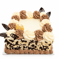 Ferrero Rocher & Chocolate Flake Celebration Cake with vanilla and chocolate buttercream swirls, white and dark chocolate flakes around the sides, Ferrero Rocher chocolates, and elegant dark chocolate decorations. Freshly made by our Sheffield bakery.