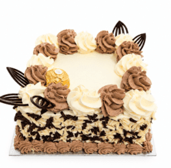 Ferrero Rocher & Chocolate Flake Celebration Cake with vanilla and chocolate buttercream swirls, white and dark chocolate flakes around the sides, Ferrero Rocher chocolates, and elegant dark chocolate decorations. Freshly made by our Sheffield bakery.