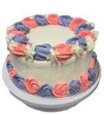 Round fresh cream cake decorated with pink and lavender fresh cream rosettes, white floral accents, textured white sides, and space for a personalised message.