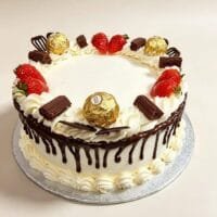 Chocolate drip celebration cake with fresh cream icing, chocolate ganache drip, fresh strawberries, Ferrero Rocher chocolates, chocolate curls, chocolate sticks and chocolate decorations, round birthday cake with space for personalised message, Cake Palace UK.