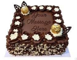Square chocolate celebration cake with smooth chocolate frosting, Ferrero Rocher chocolates, chocolate leaf decorations, white cream flowers, mixed chocolate curls around the sides, and a personalised message area in the centre.