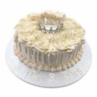 Elegant Ivory Crown Wedding Cake with ivory fresh cream rosettes, silver crown topper, egg-free vanilla or chocolate sponge from Cake Palace.