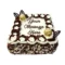 Square fresh cream celebration cake decorated with chocolate and vanilla swirls, white floral piping, Ferrero Rocher chocolates, chocolate leaf decorations, milk and white chocolate shavings, and a personalised message.